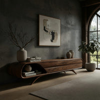 Mid century TV console with a rounded open end on splayed legs in a concrete and timber loft