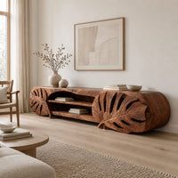 Long tv stand with monstera leaf carved ends and open shelves in the center in a Scandinavian living room with white walls