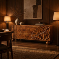 Sideboard with a carved monstera leaf on the right doors and ball feet in an evening dining room with walnut wall paneling