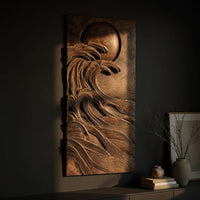 Dark wooden wall relief of a moon over waves, three-quarter view showing the carved depth