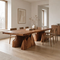 Live edge dining table on two wedge pedestals with jagged peak tops in a Scandinavian dining room with white walls