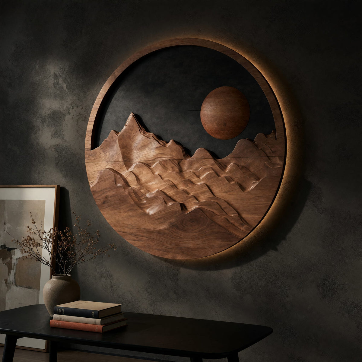 Round wooden mountain wall hanging with a black sky on a dark charcoal plaster wall