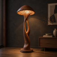 Floor lamp with a mushroom cap shade and a sculpted open stem, three-quarter view showing the grain