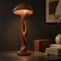 Corner detail of floor lamp with a mushroom cap shade and a sculpted open stem beside wood, brass and linen samples