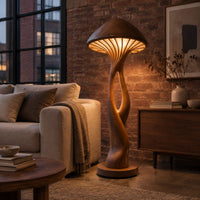 Floor lamp with a mushroom cap shade and a sculpted open stem in an industrial loft living room with exposed brick
