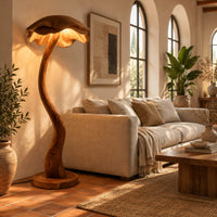 Floor lamp with a winding wooden stem and a wavy mushroom cap shade in a bright living room with arched windows and plants