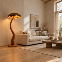 Floor lamp with a winding wooden stem and a wavy mushroom cap shade in a bright open plan living room