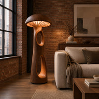 Mushroom floor lamp with a domed cap and tall carved stem in an industrial loft living room with exposed brick
