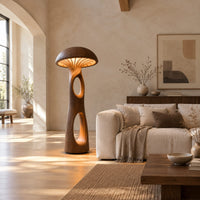 Mushroom floor lamp with a domed cap and tall carved stem in a bright open plan living room
