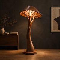 Mushroom floor lamp with a slim curving stem and a ribbed glowing cap in a dark studio against a charcoal plaster wall