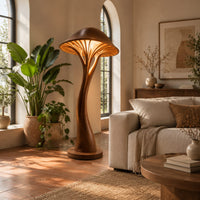 Mushroom floor lamp with a slim curving stem and a ribbed glowing cap in a bright living room with arched windows and plants