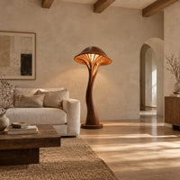 Mushroom floor lamp with a slim curving stem and a ribbed glowing cap in a bright open plan living room