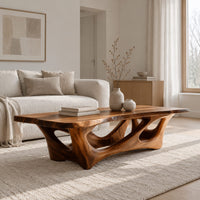 Natural edge coffee table with an open branching wood base in a Scandinavian living room with white walls
