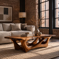 Natural edge coffee table with an open branching wood base in an industrial loft living room with exposed brick
