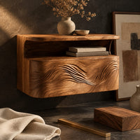 Corner detail of floating nightstand with a carved wave front and an open nook under the top beside wood, brass and linen samples