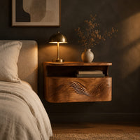 Floating nightstand with a carved wave front and an open nook under the top in a dark bedroom at golden hour