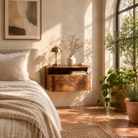 Floating nightstand with a carved wave front and an open nook under the top in a bright bedroom with arched windows and plants