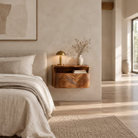 Floating nightstand with a carved wave front and an open nook under the top in a bright open plan bedroom