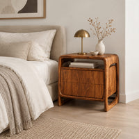Nightstand with an open top cubby and a looped side frame in a Scandinavian bedroom with white walls