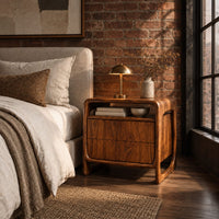 Nightstand with an open top cubby and a looped side frame in an industrial loft bedroom with exposed brick