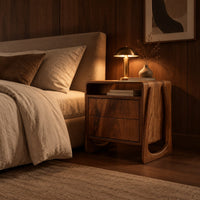 Nightstand with an open top niche and sculpted loop shaped sides in an evening bedroom with walnut wall paneling