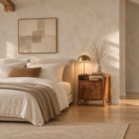 Nightstand with an open top niche and sculpted loop shaped sides in a bright open plan bedroom