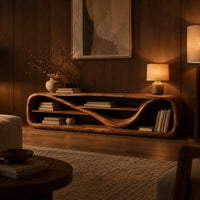 Low open capsule shaped media console with a winding shelf running through it in an evening living room with walnut wall paneling