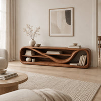 Low open capsule shaped media console with a winding shelf running through it in a Scandinavian living room with white walls