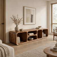 Low tv stand with soft edges and a stacked pair of oval cubbies in a Scandinavian living room with white walls