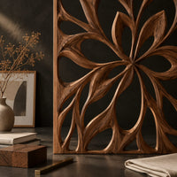 Corner detail of room divider with a large open flower pattern of sweeping petals beside wood, brass and linen samples