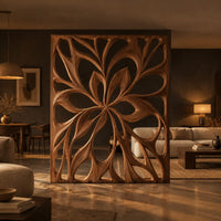 Room divider with a large open flower pattern of sweeping petals in a dark open-plan living room at golden hour