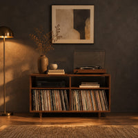 Open turntable stand with four square bays and short tapered legs in a dark living room at golden hour