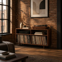 Open turntable stand with four square bays and short tapered legs in an industrial loft living room with exposed brick