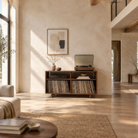 Open turntable stand with four square bays and short tapered legs in a bright open plan living room