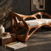 Corner detail of wooden bench with a pale cushioned seat and an organic open frame beside wood, brass and linen samples