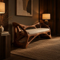 Wooden bench with a pale cushioned seat and an organic open frame in an evening entryway with walnut wall paneling