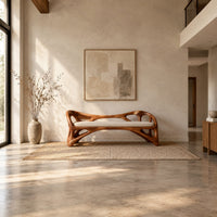 Wooden bench with a pale cushioned seat and an organic open frame in a bright open plan entryway