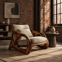 Open frame wooden lounge chair with thick sculpted loops and cream cushions in an industrial loft living room with exposed brick