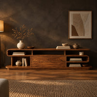 Low tv stand with open cubbies, a wide center panel and stacked end shelves in a dark living room at golden hour