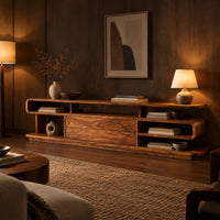Low tv stand with open cubbies, a wide center panel and stacked end shelves in an evening living room with walnut wall paneling