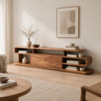 Low tv stand with open cubbies, a wide center panel and stacked end shelves in a Scandinavian living room with white walls