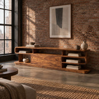 Low tv stand with open cubbies, a wide center panel and stacked end shelves in an industrial loft living room with exposed brick