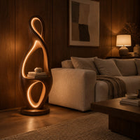 Tall floor lamp shaped as a looping figure eight with a small shelf in an evening living room with walnut wall paneling