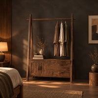 Open rail wardrobe with slanted side posts and a low cabinet base in a dark bedroom at golden hour