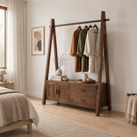 Open rail wardrobe with slanted side posts and a low cabinet base in a Scandinavian bedroom with white walls