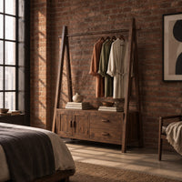 Open rail wardrobe with slanted side posts and a low cabinet base in an industrial loft bedroom with exposed brick
