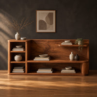 Open shelf console table with a grain back panel and a side cubby stack in a dark studio against a charcoal plaster wall