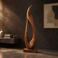 Tall teardrop sculpture with an open center and a pointed tip, three-quarter view showing the grain