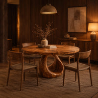 Round dining table with an open teardrop loop pedestal base in an evening dining room with walnut wall paneling