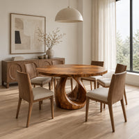 Round dining table with an open teardrop loop pedestal base in a Scandinavian dining room with white walls